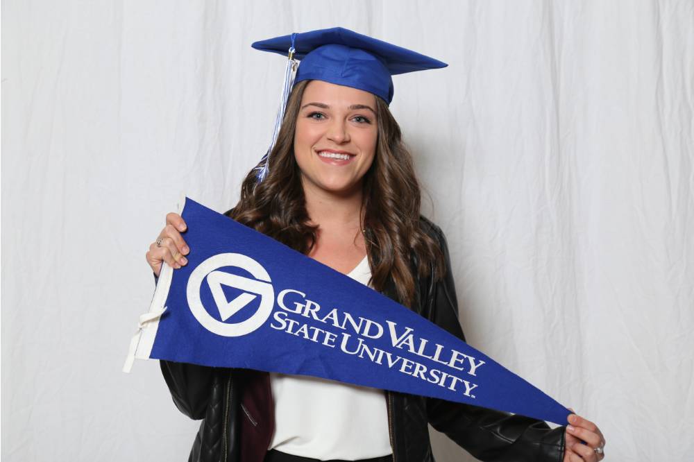 A future alumna poses with GV flag at GradFest
